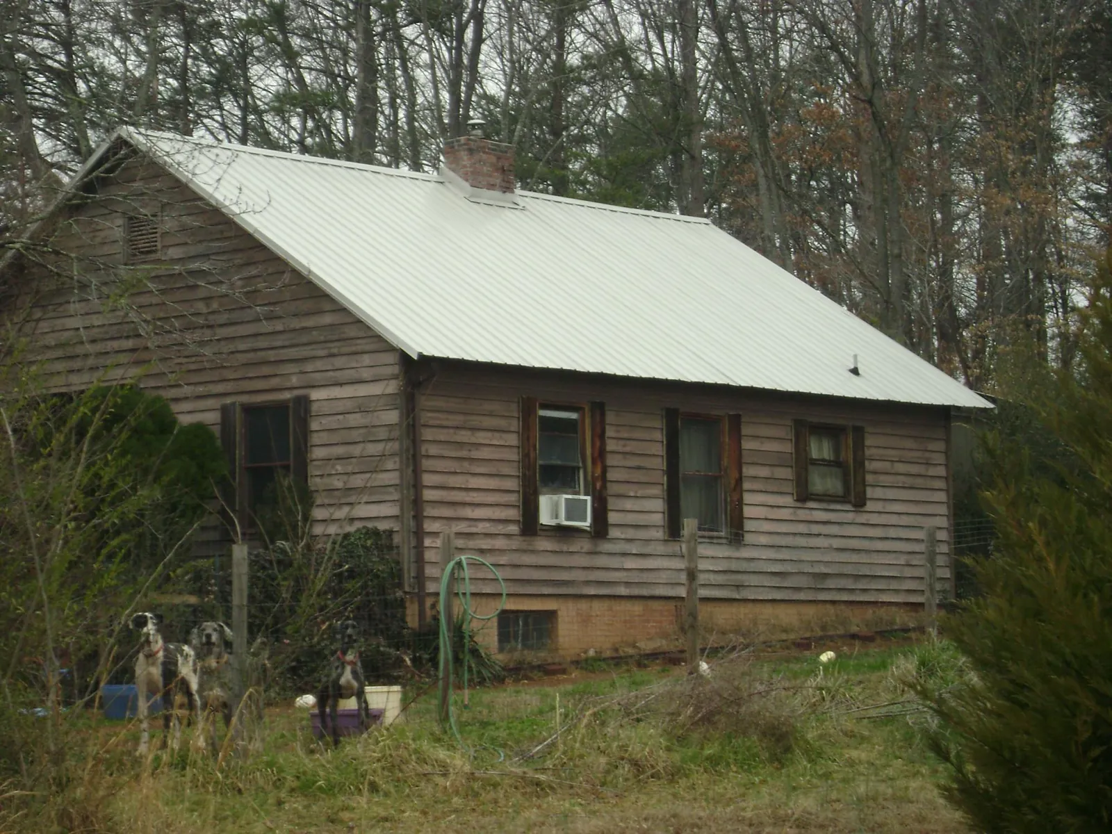 White metal roof on an old wood sided farmhouse, from a Metal Roof Installation job in Cathedral City